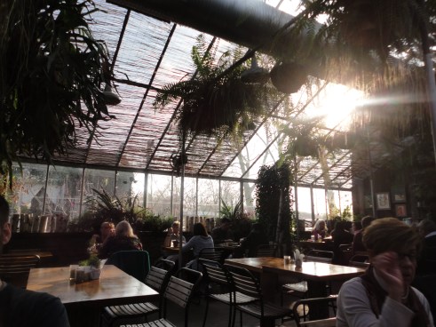 The dining room is like a giant terrarium filled with seasonal plants and sunlight