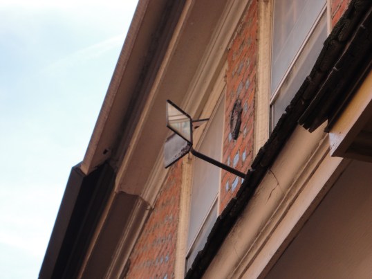 This three sided mirror is called a "busybody" - the perfect invention for knowing who's creeping at your front door