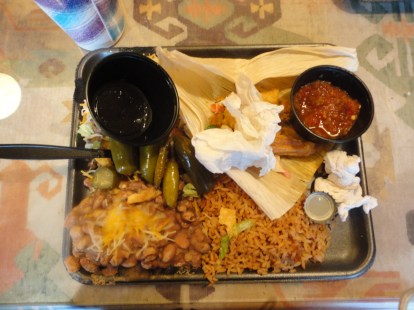 The remnants of a half-eaten meal on a flat, styrofoam loco-style plate.