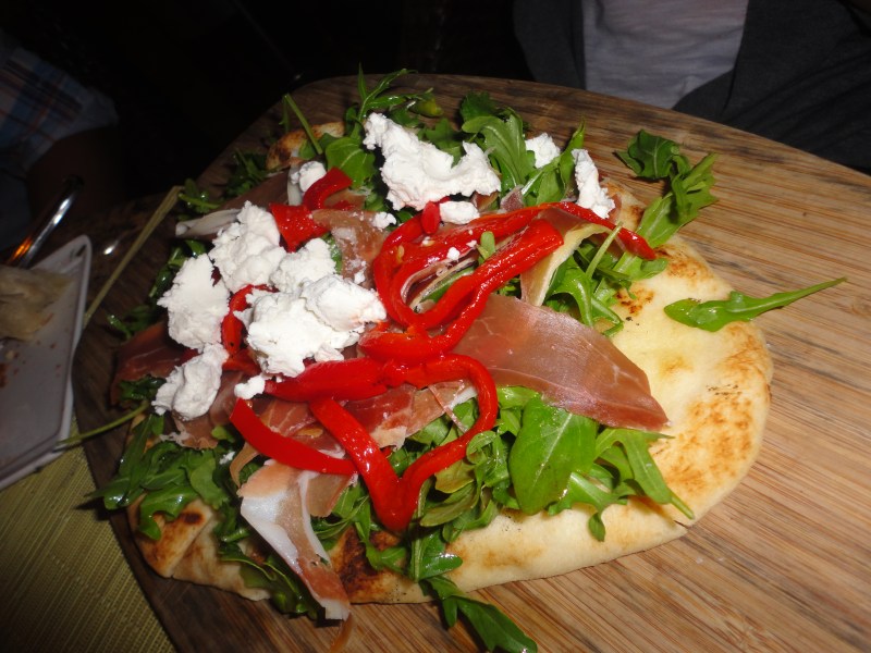 Flatbread with goat cheese, roasted red peppers and some kind of ham--another delicious starter