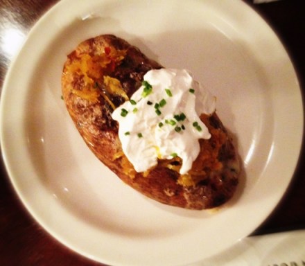 Keystone Cannibal baked potato stuffed with scrapple-yukon gold hash,  sharp cheddar and topped with sour cream and hot chow chow